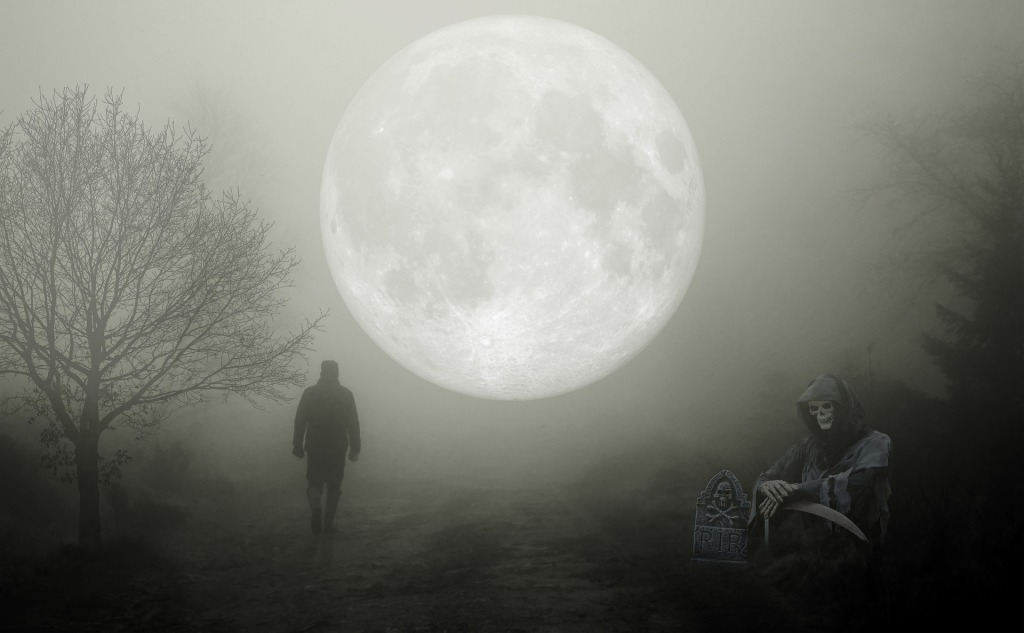 Man walking in grey Halloween night under big moon with the grim reaper